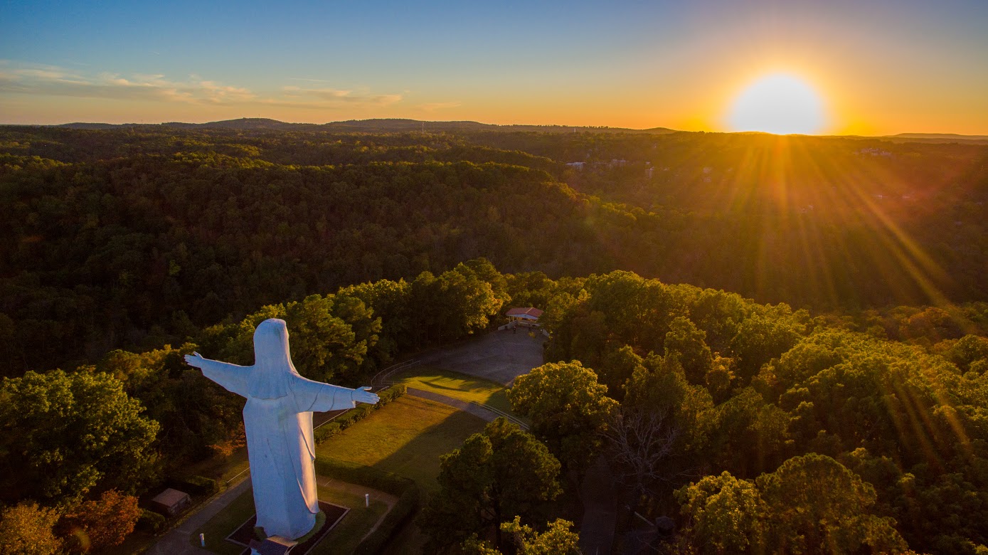 The Christ of the Ozarks statue facing the rising sun, a popular thing to do for visitors in Eureka Springs.